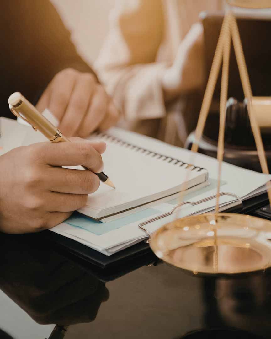 Scales of justice and legal notes on a desk